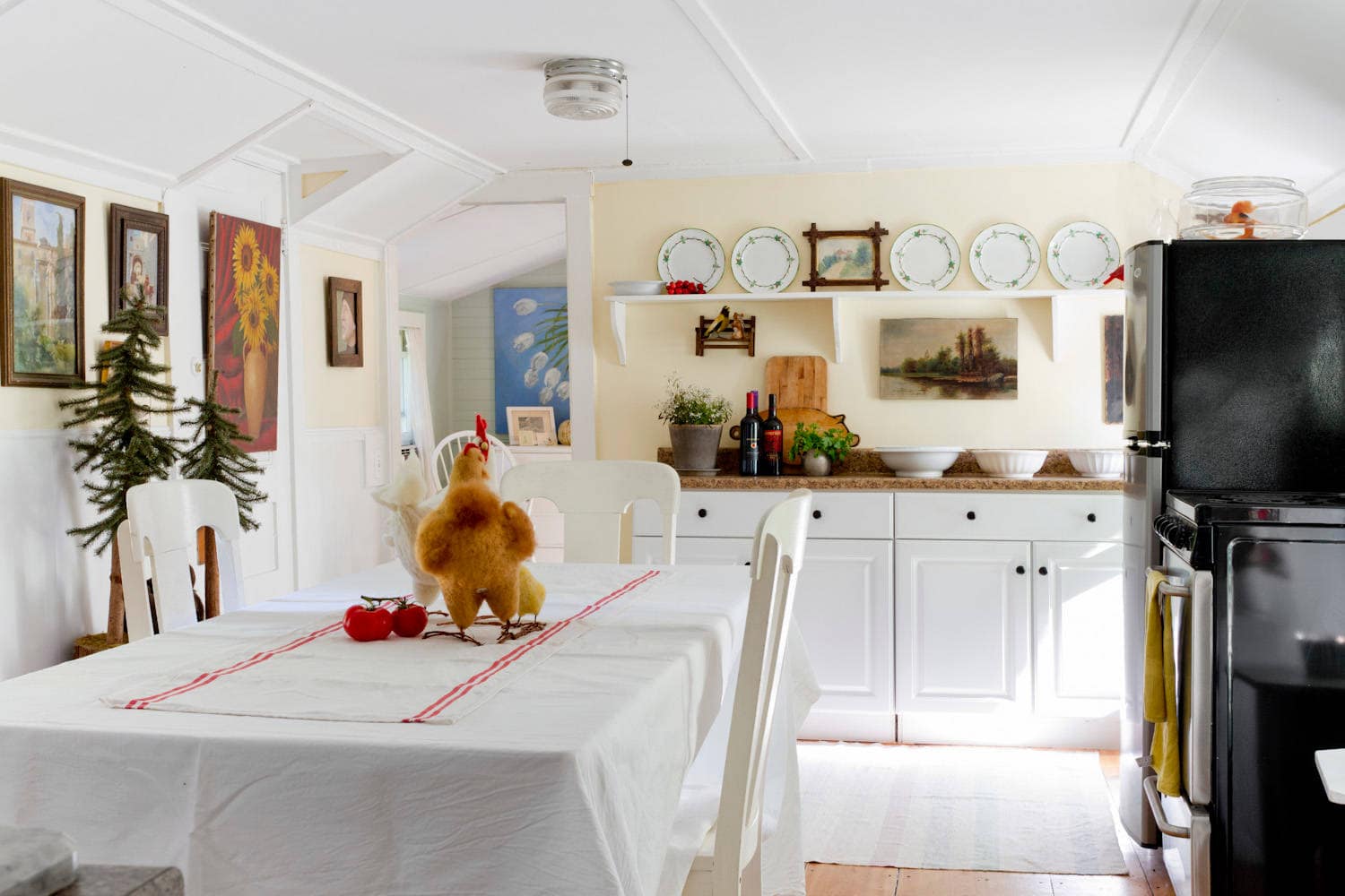 Whimsical and retro rustic style in a cottage kitchen featured in home tour, pale yellow walls.