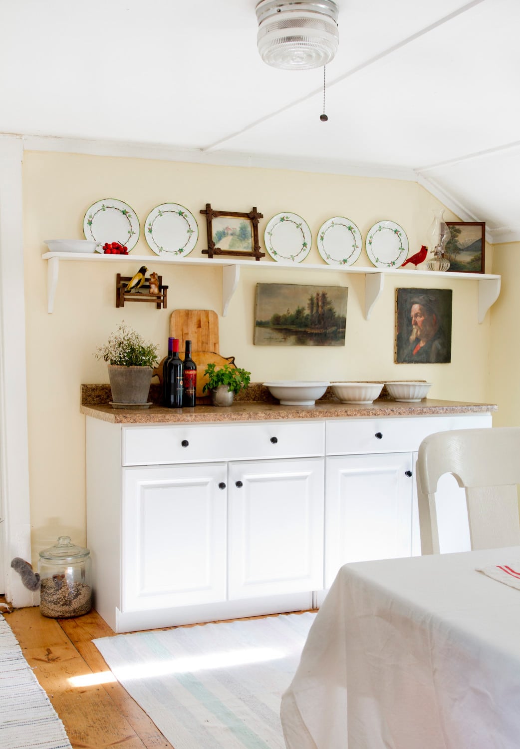 Whimsical and retro rustic style in a cottage kitchen featured in home tour, pale yellow walls.