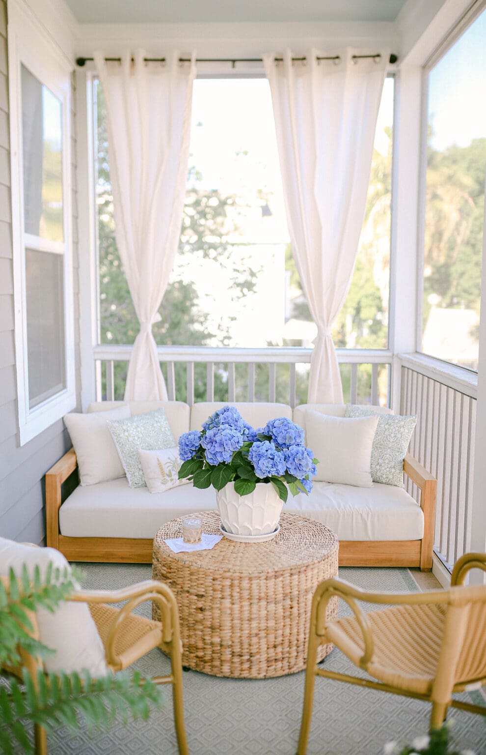 Front porch featuring sofa with curtains featured in outdoor decorating ideas