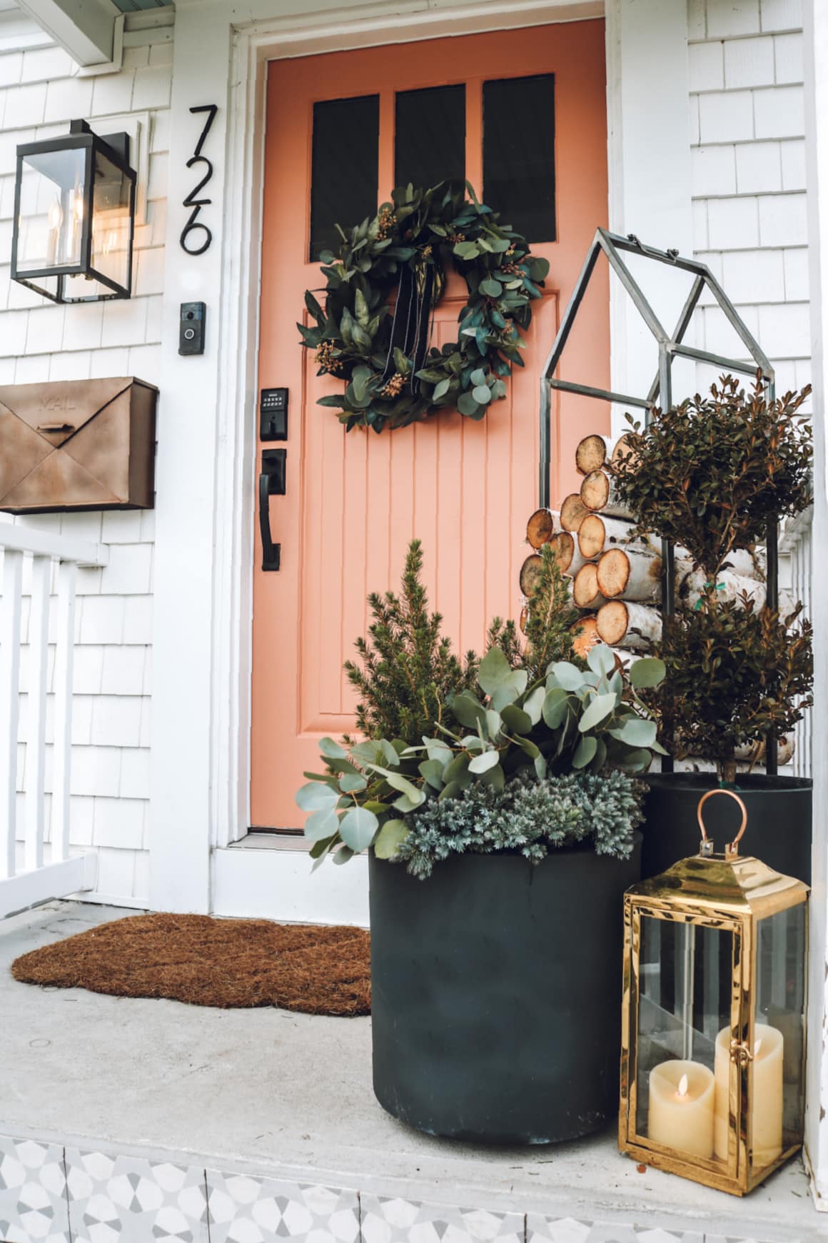 Pink salmon front door featuring green wreath outdoor decorating ideas