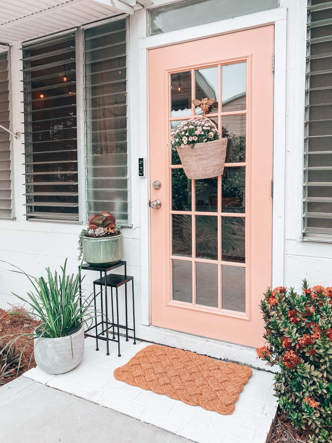 Pink salmon front door featuring floral basket outdoor decorating ideas