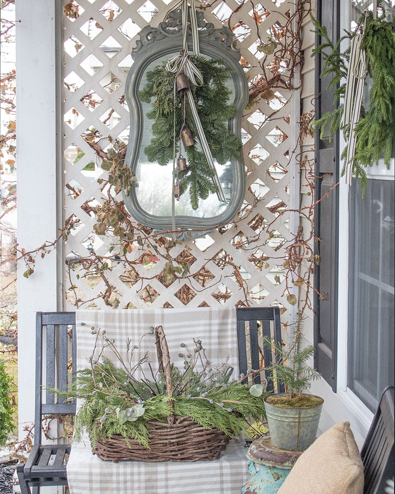 Outdoor decorating ideas featuring mirror against privacy screen