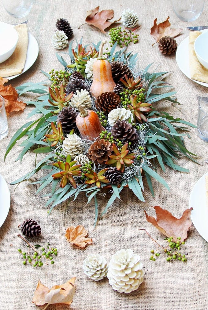 Centerpiece idea featuring wooden bowl filled with plants