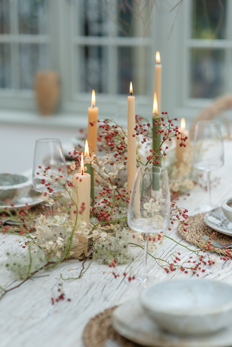 Delicate centerpiece idea featuring tapered candles with baby breath flowers