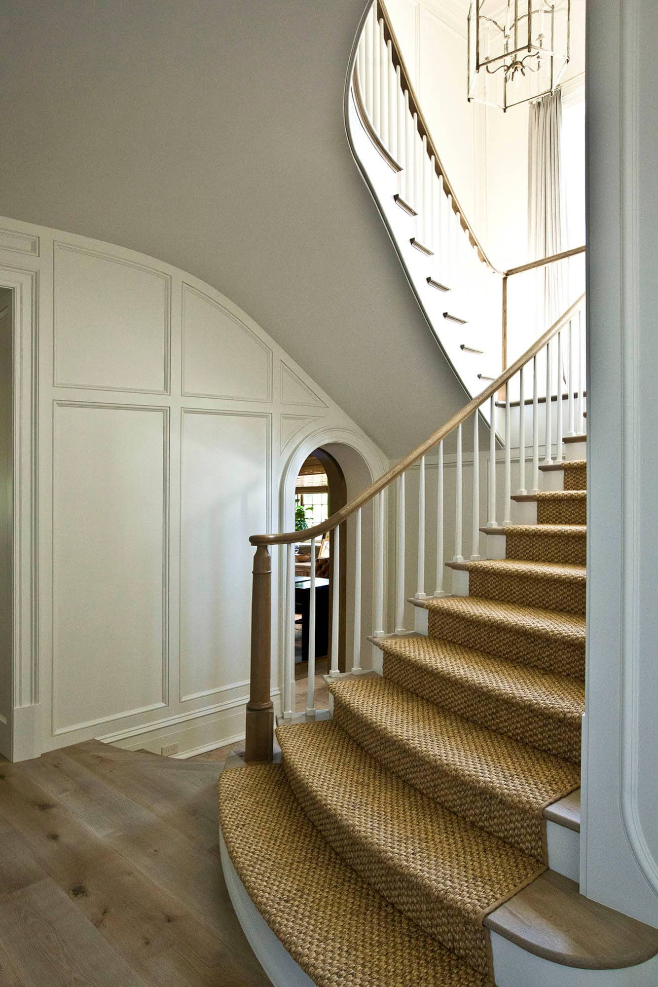 staircase featured in home tour that showcases an arched staircase and details