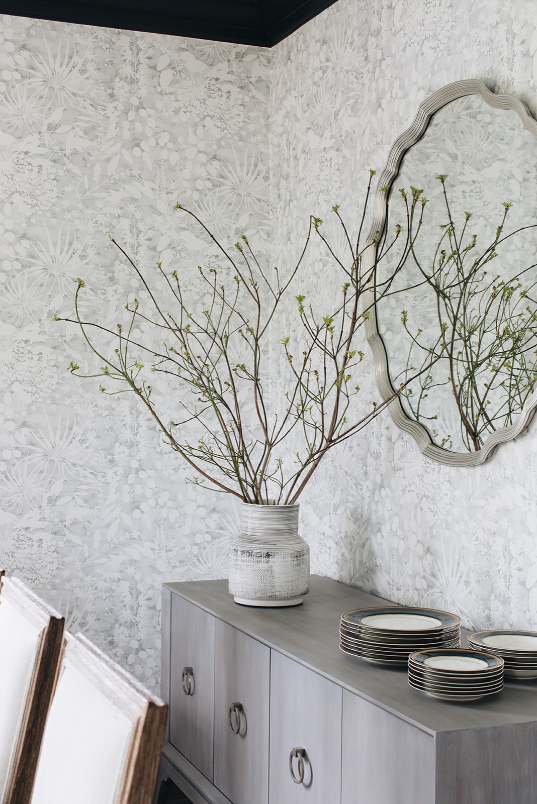 Dining room in home tour featuring sideboard decorated with cherry branches inside vase