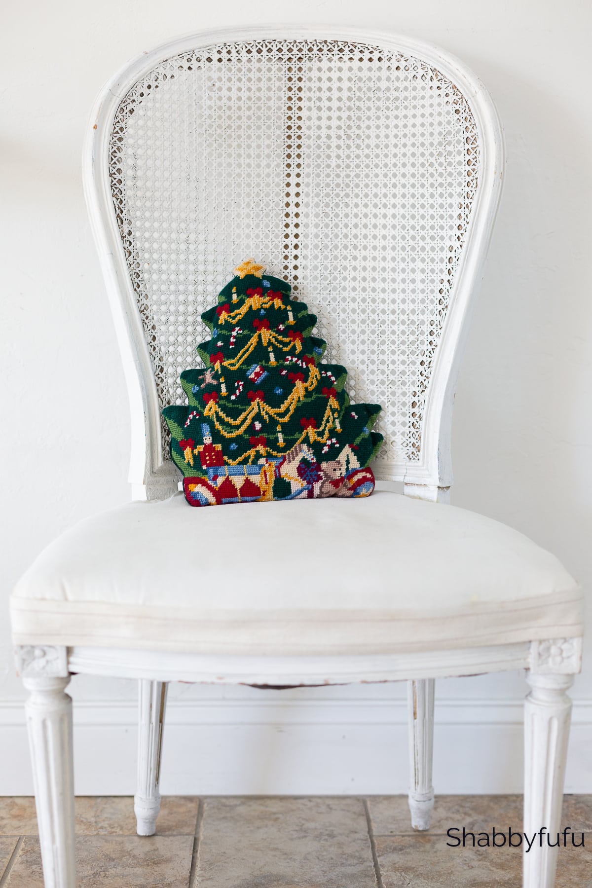 vintage chair with Christmas needlepoint pillow