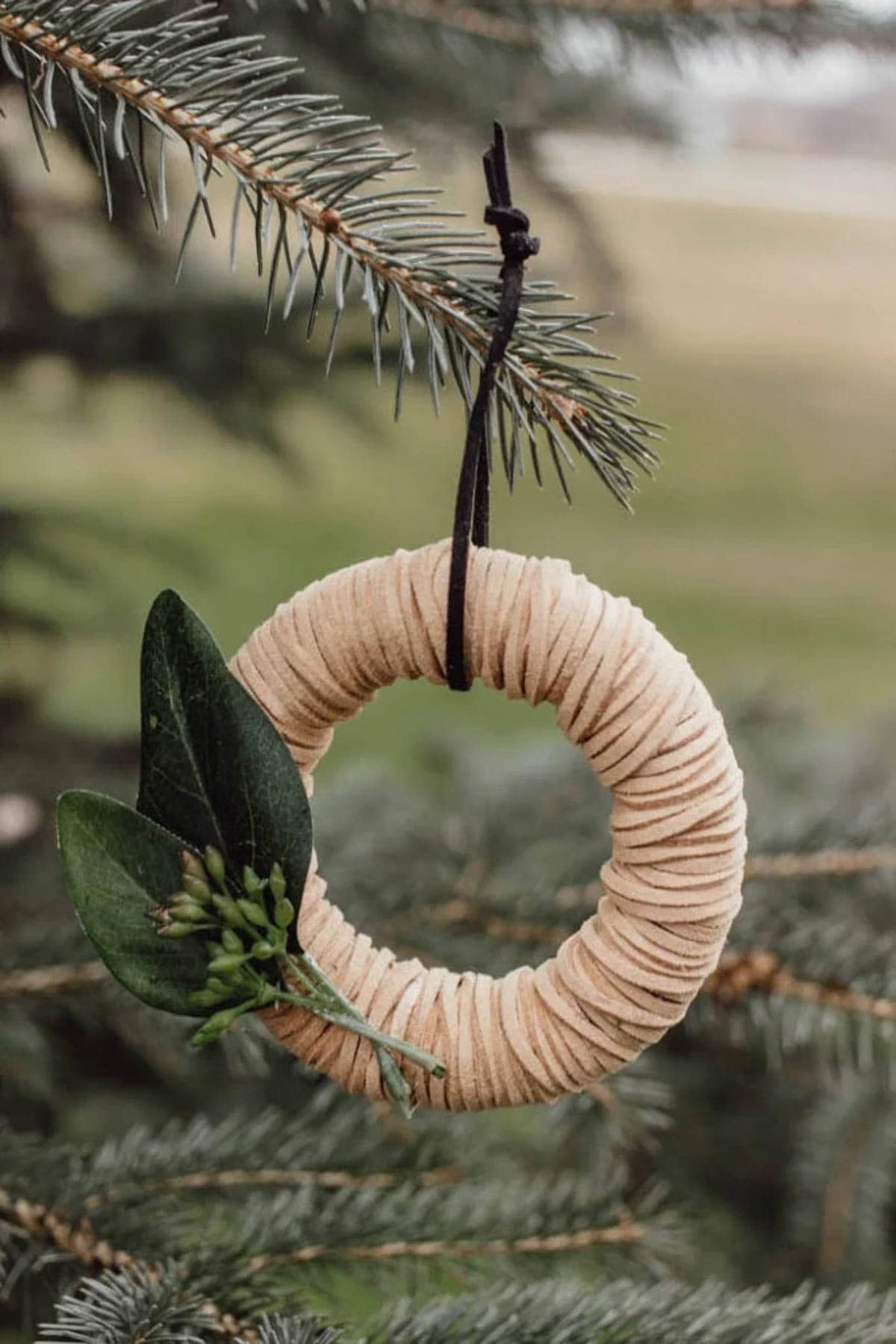 mini leather wreath idea hanging from a tree