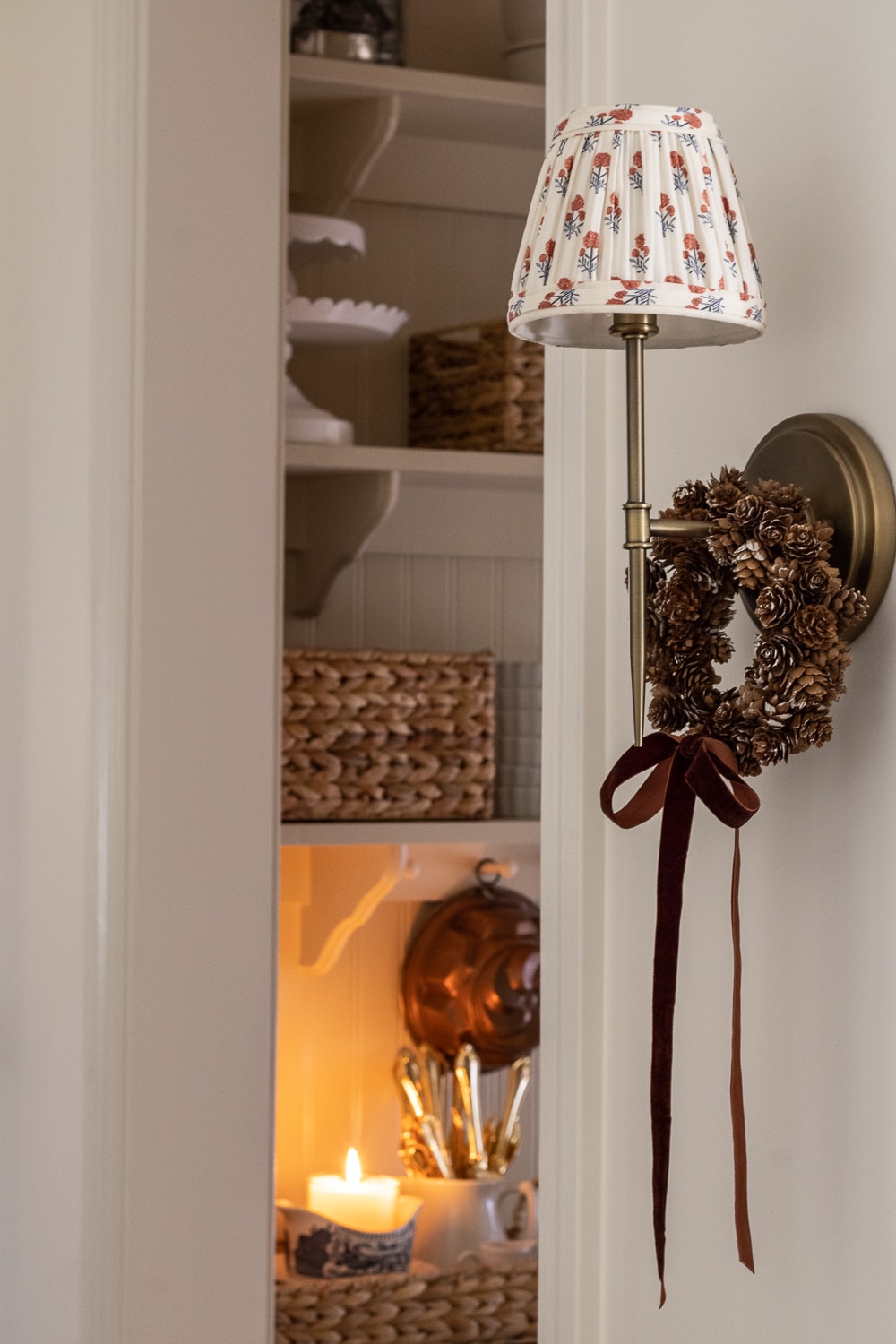 wreath idea featuring a mini wreath hang on a scone light