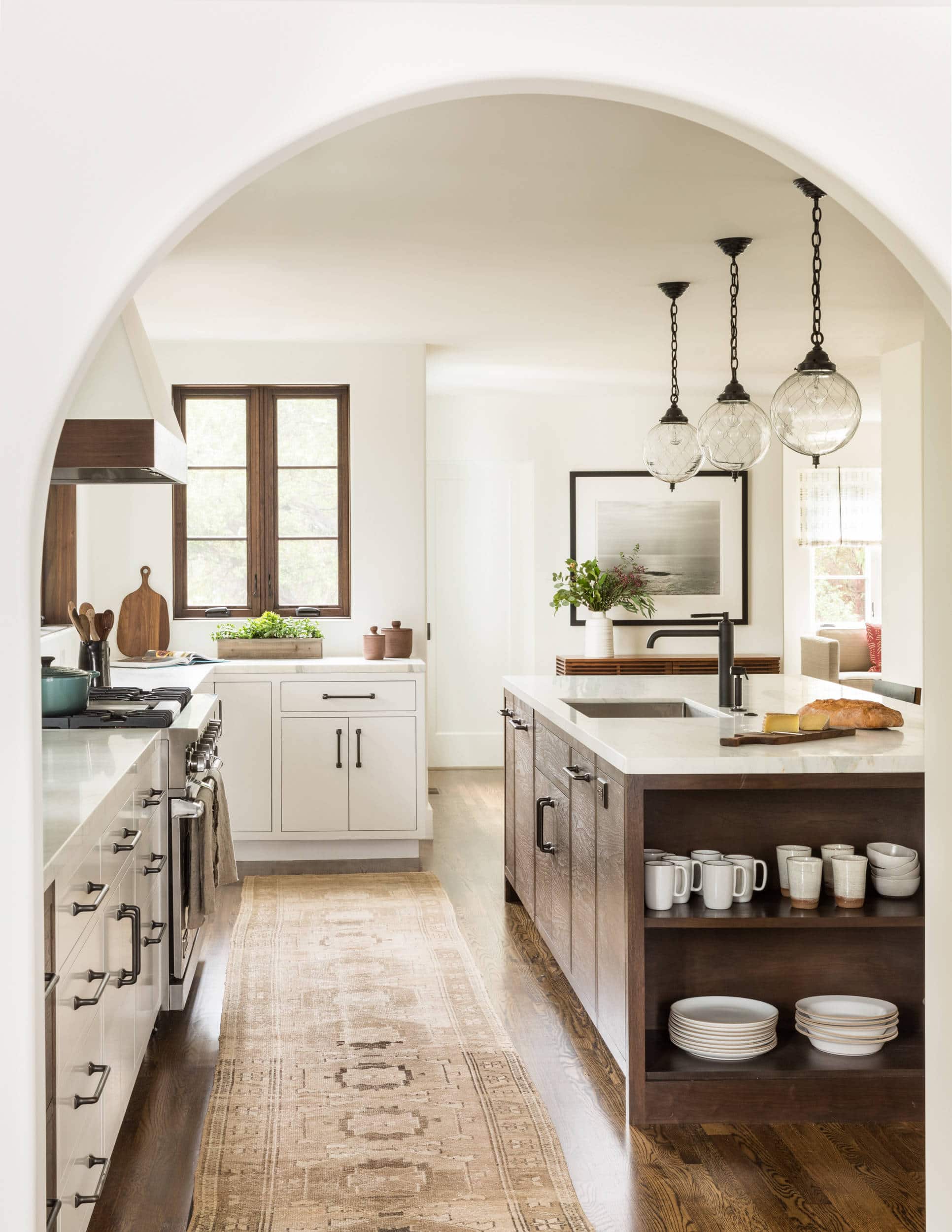 California Casual Design home tour in Hillsborough featuring modern warm neutral kitchen with a dark wood kitchen island