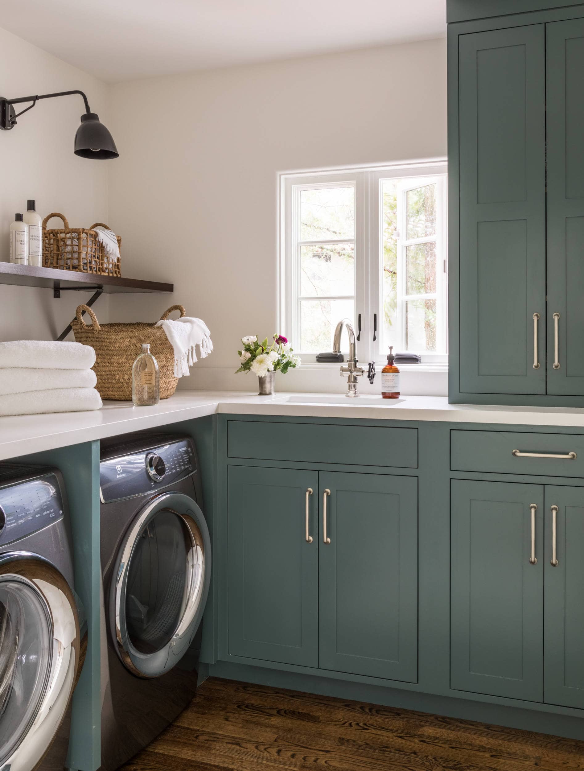 California Casual Design style laundry room featuring blueish green cabinets