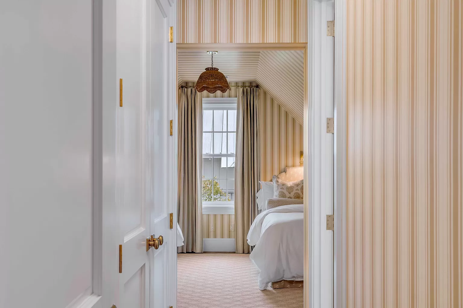 Traditional guest bedroom featured in Charleston Harbor home tour striped yellow walls