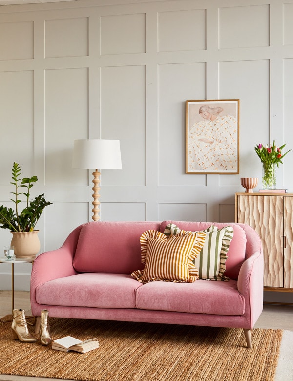 home decor design trends for 2024 featuring living room with pink sofa and ruffled pillows
