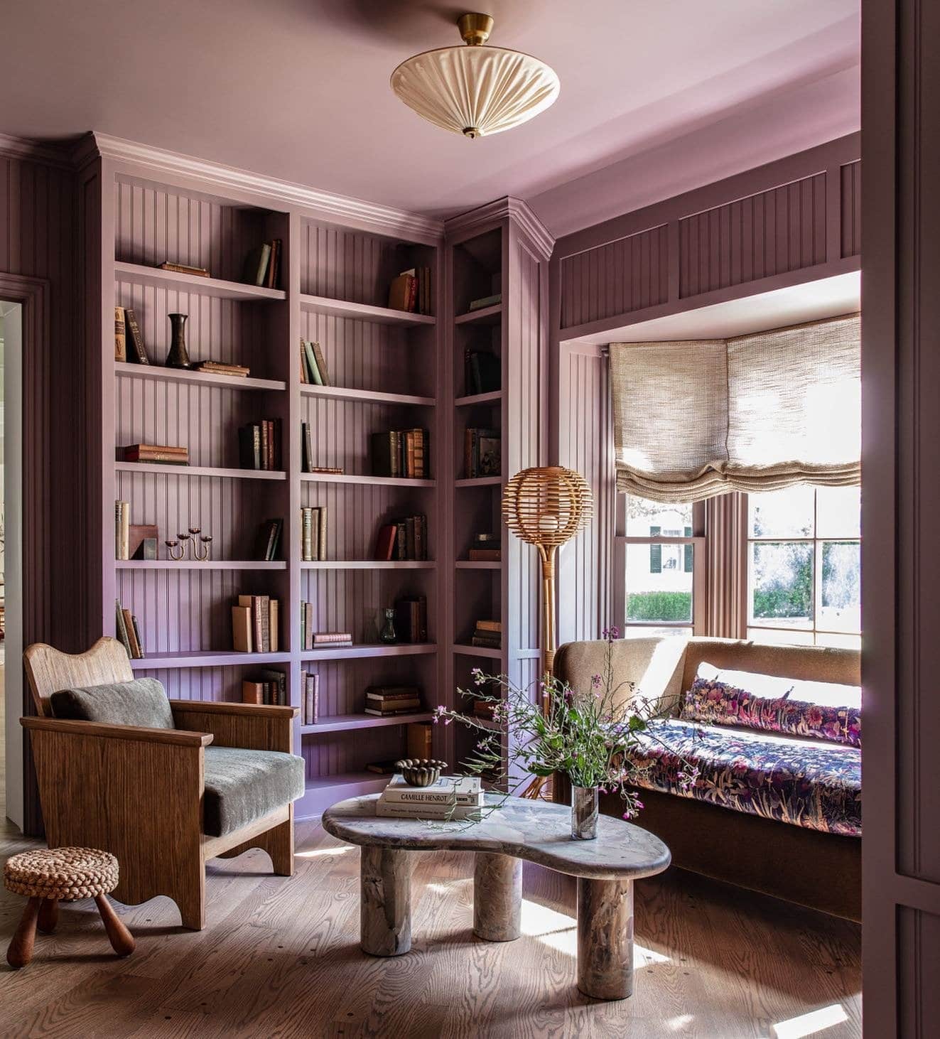 living room featuring purple walls styled with trendy decor elements featured in "Timeless vs. Trendy Decor" 