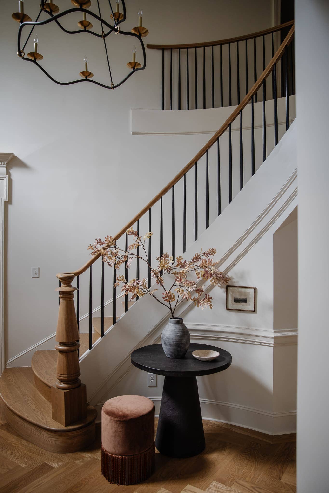 Traditional staircase with side table in timeless decor style featured in "Timeless vs. Trendy Decor" 