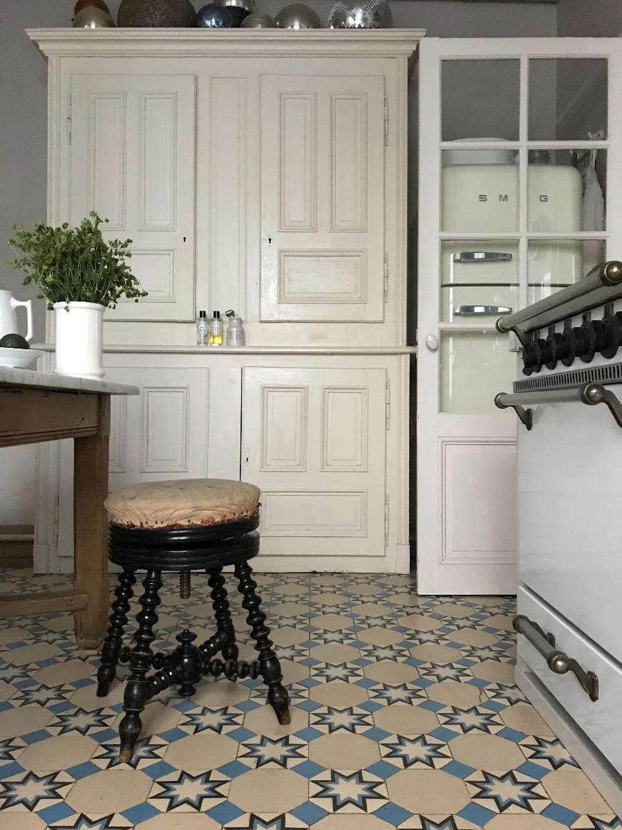 Rustic french style kitchen with antique tiles featured as a example of old homes timeless charm