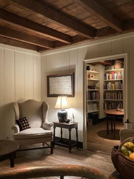 Timeless allure of old homes example showcasing a living room with traditional wood beams, reading nook
