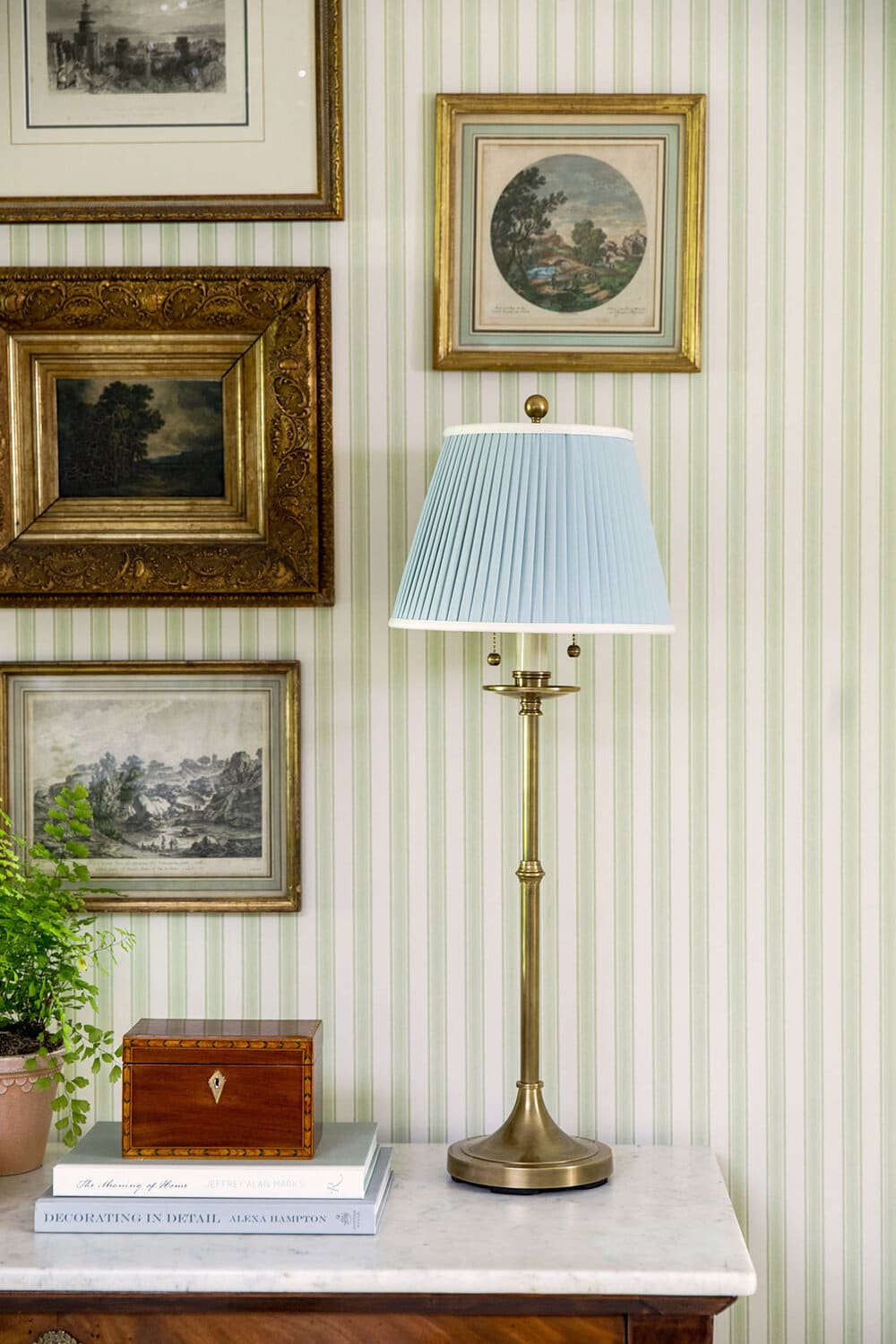 example of mixing patterns and textures in a traditional home featuring striped wallpaper and framed artwork