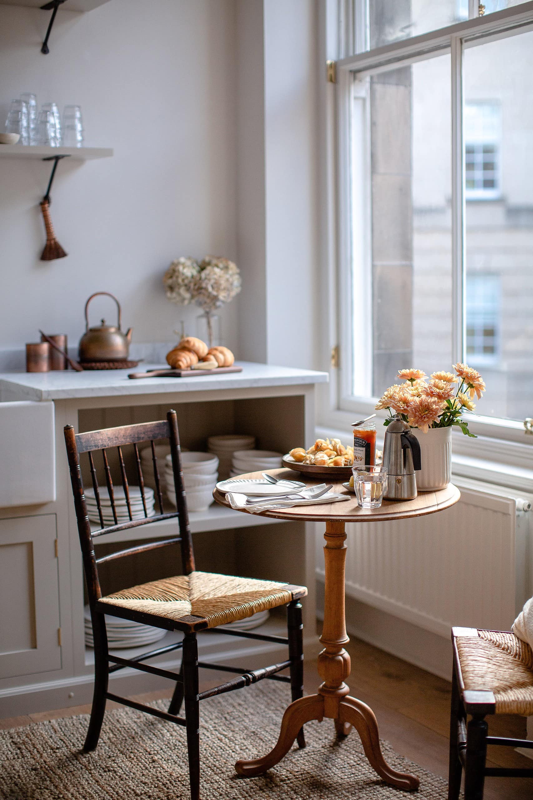 Kitchen room featuring windows and small bistro table as an example of Style Small Space Ideas