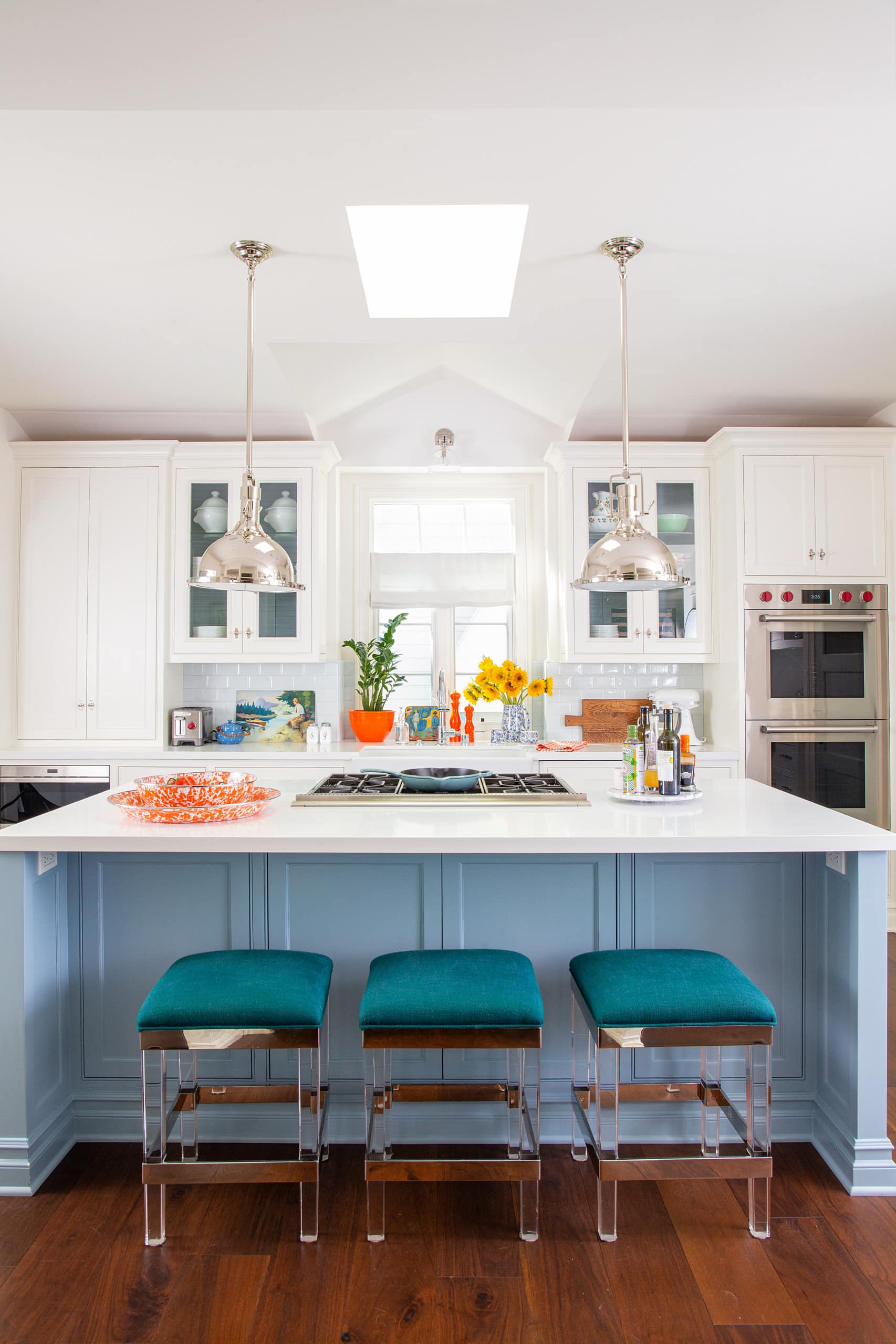 Cheery beach style retreat kitchen featuring white and blue color scheme featured in home tour