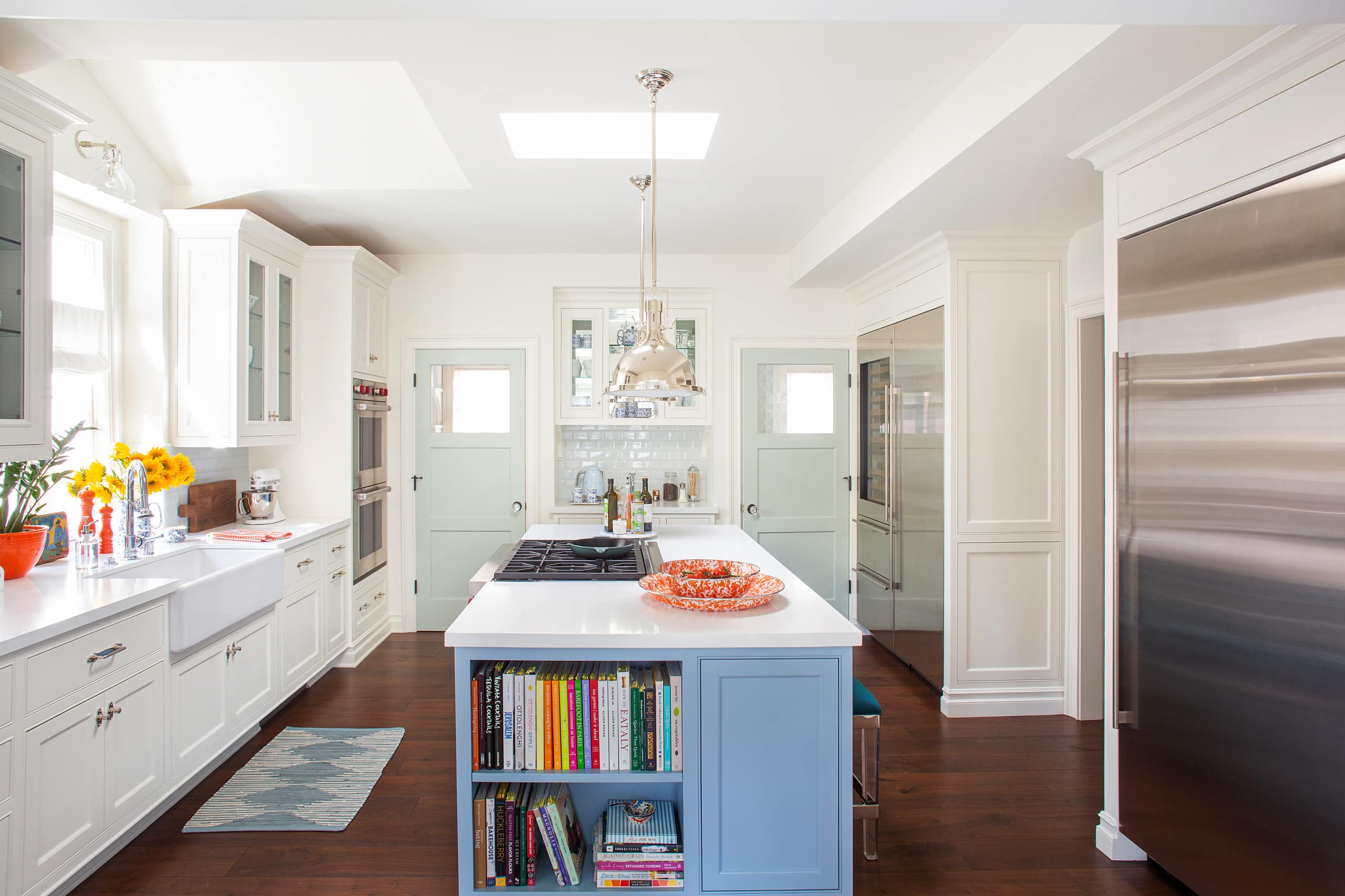 Cheery beach style retreat kitchen featuring white and blue color scheme featured in home tour
