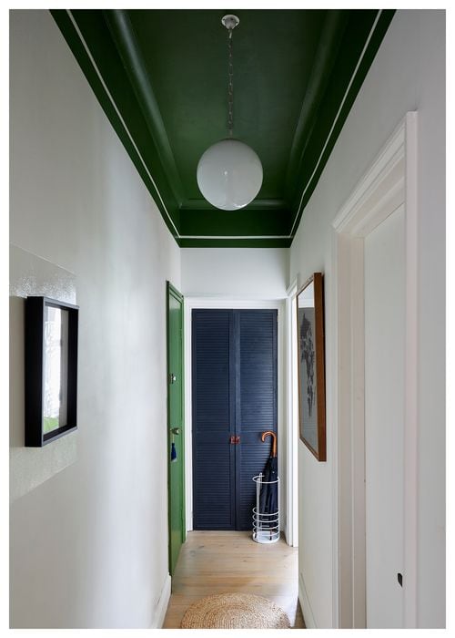 Hallway featuring architectural details green ceiling