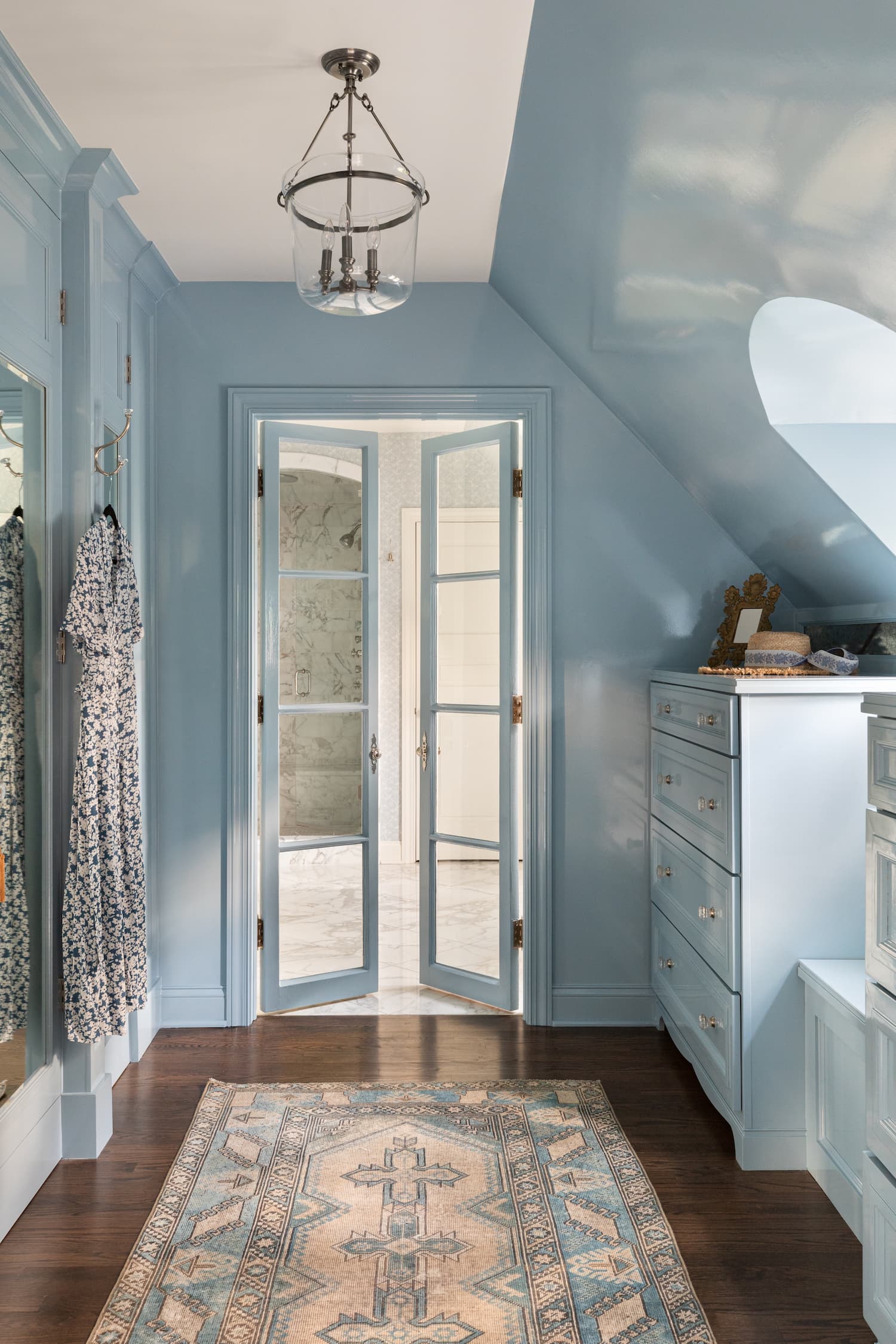 Fresh young design with traditional style walk-in closet in light blue by Alexandra Kaehler.