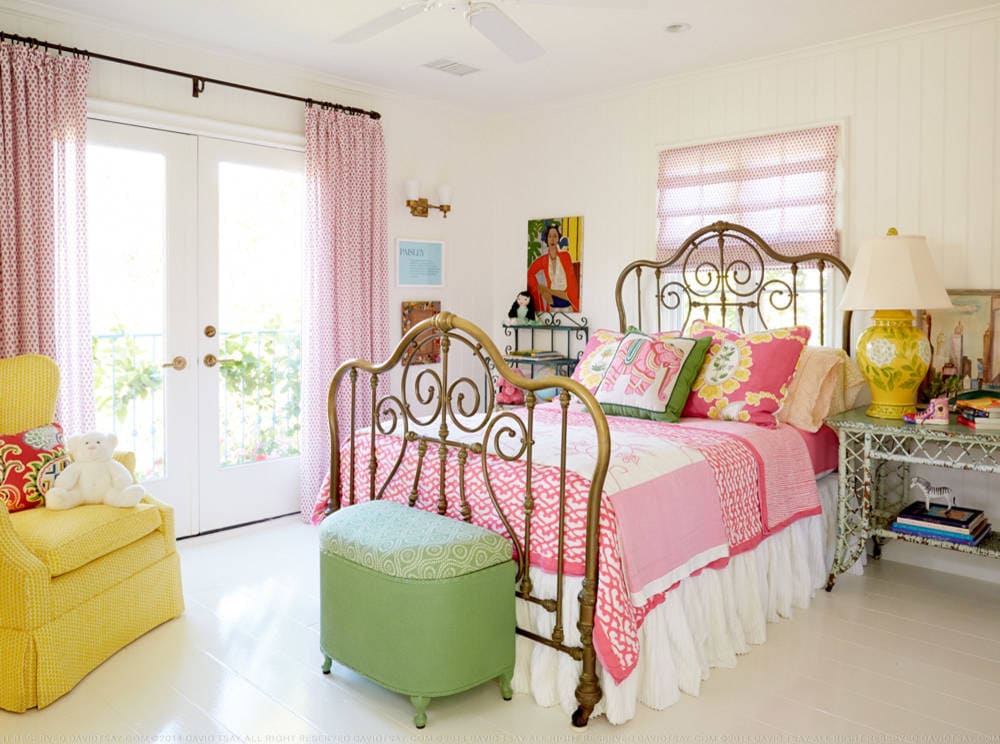 Bedroom in beach english cottage style featuring colorful bedding with boho style