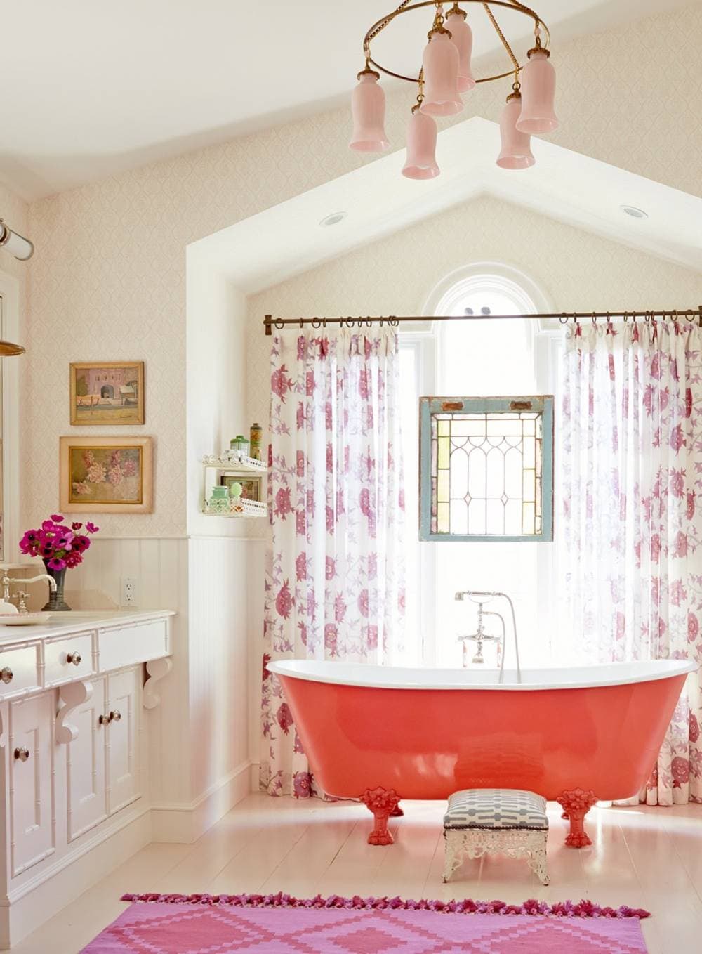 Bathroom in beach english cottage style featuring red bathtub and pink accents