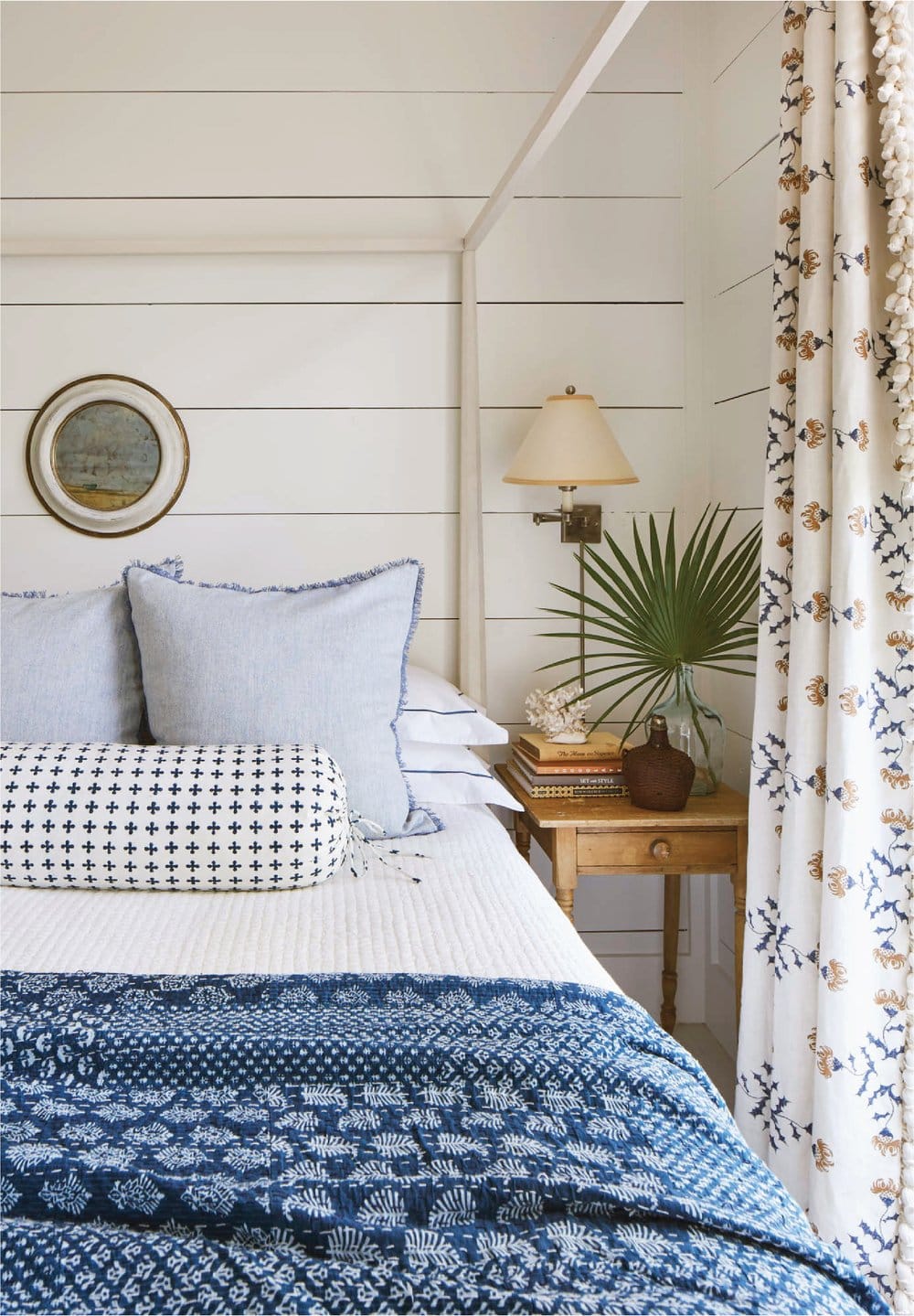 White and blue bedroom with coastal style featured in interiors designed by Heather Chadduck