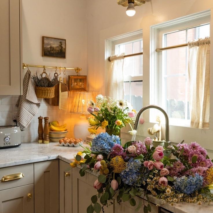 Kitchen featuring a traditional floral arrangement next to the sink shown as example for old and outdated kitchen ideas