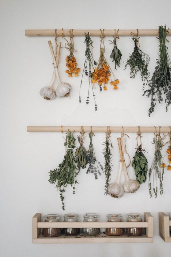 Rack with dried hanging herbs featured in summer decor ideas