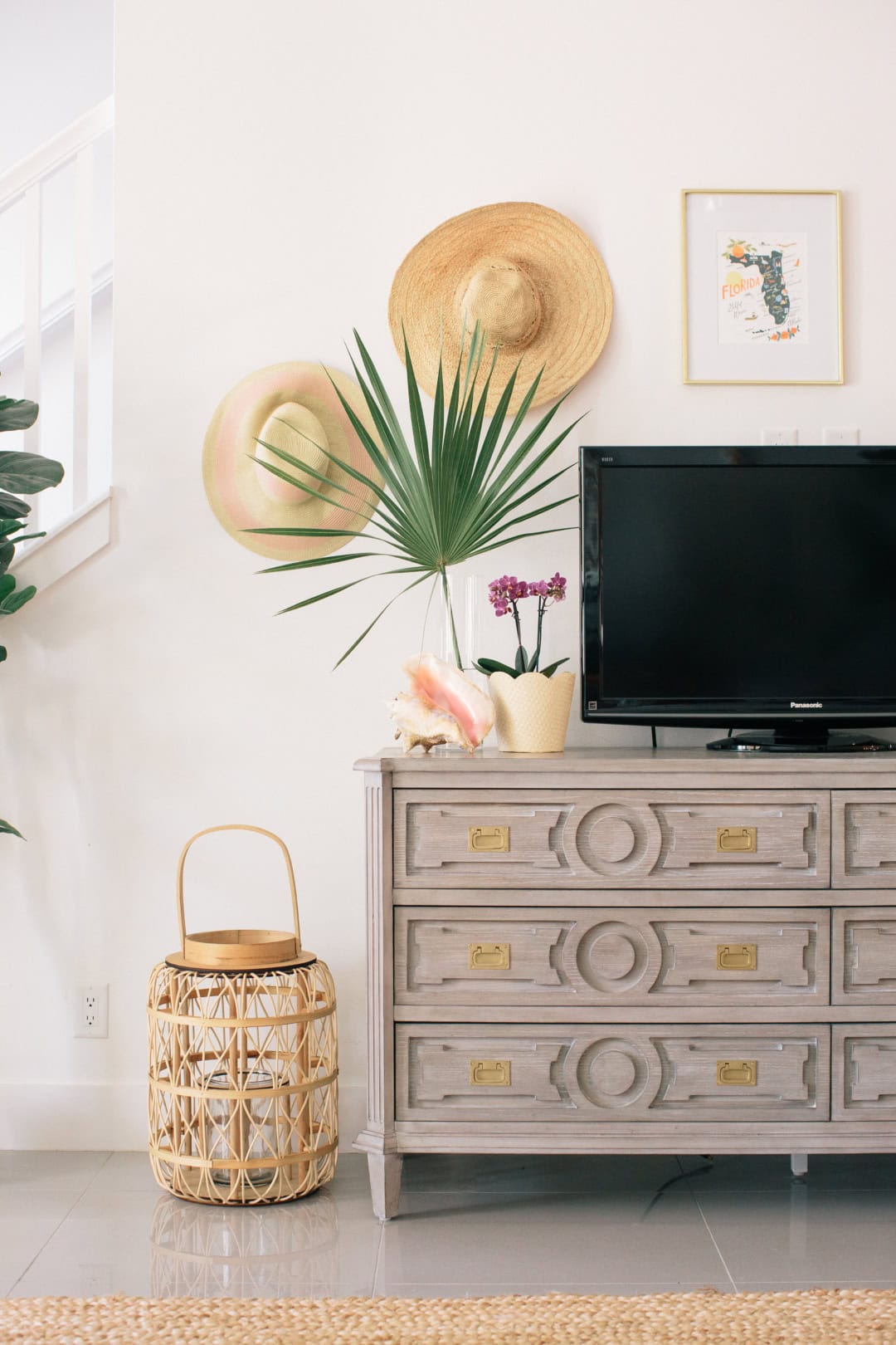 Entryway with sun hats displayed on wall featured in summer decor tips