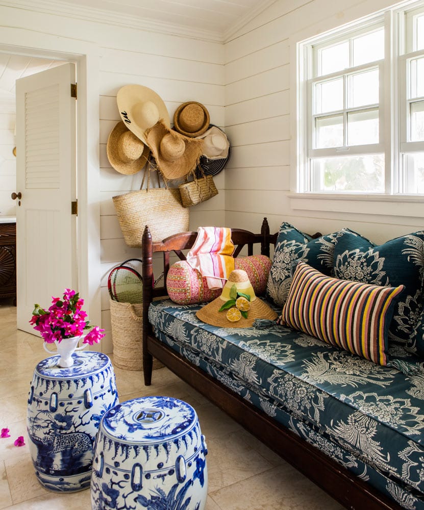 Entryway with sun hats displayed on wall featured in summer decor tips