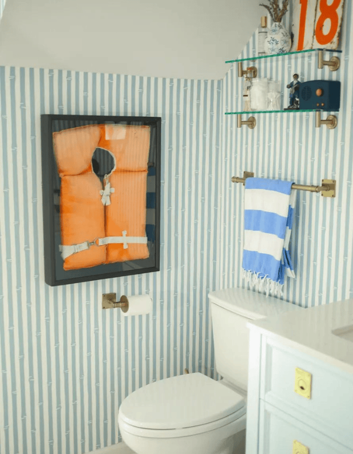 Idea to embrace a nautical theme decor featuring bathroom with striped wallpaper