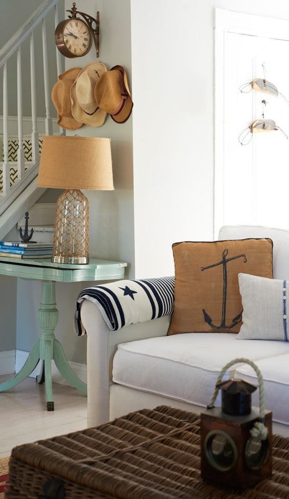 Idea to embrace a nautical theme decor featuring living room with anchor pillows