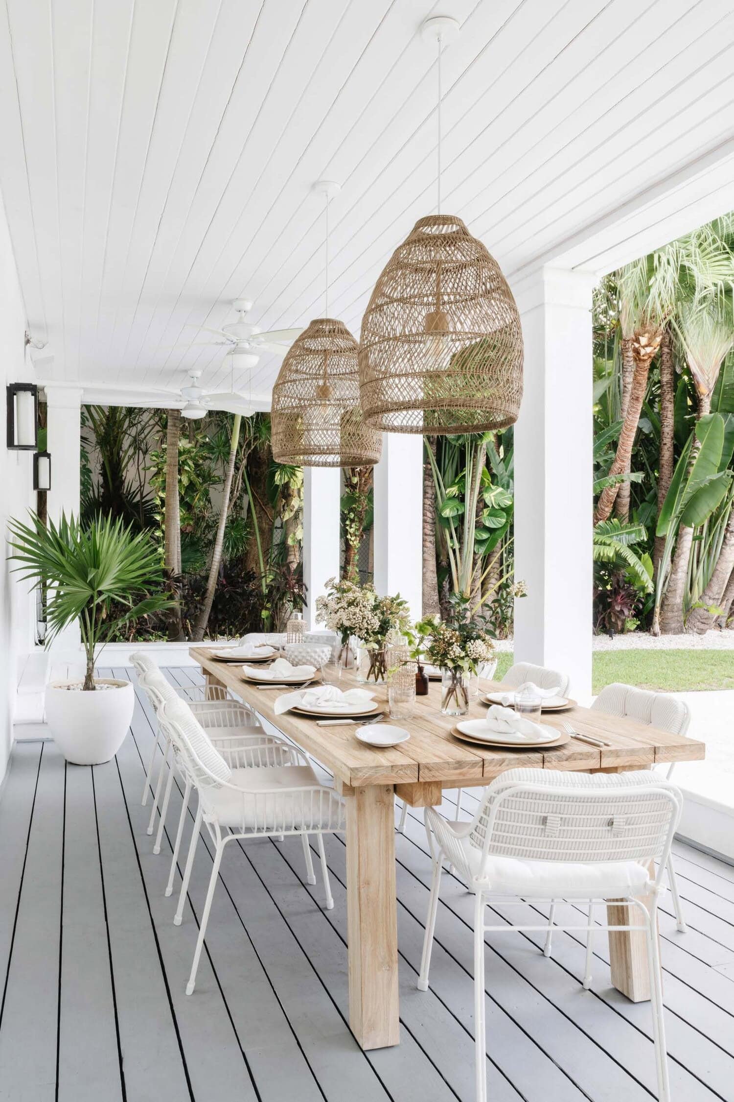 Tropical decor style outdoor gallery featuring a dining table and rustic tropical decor lamps