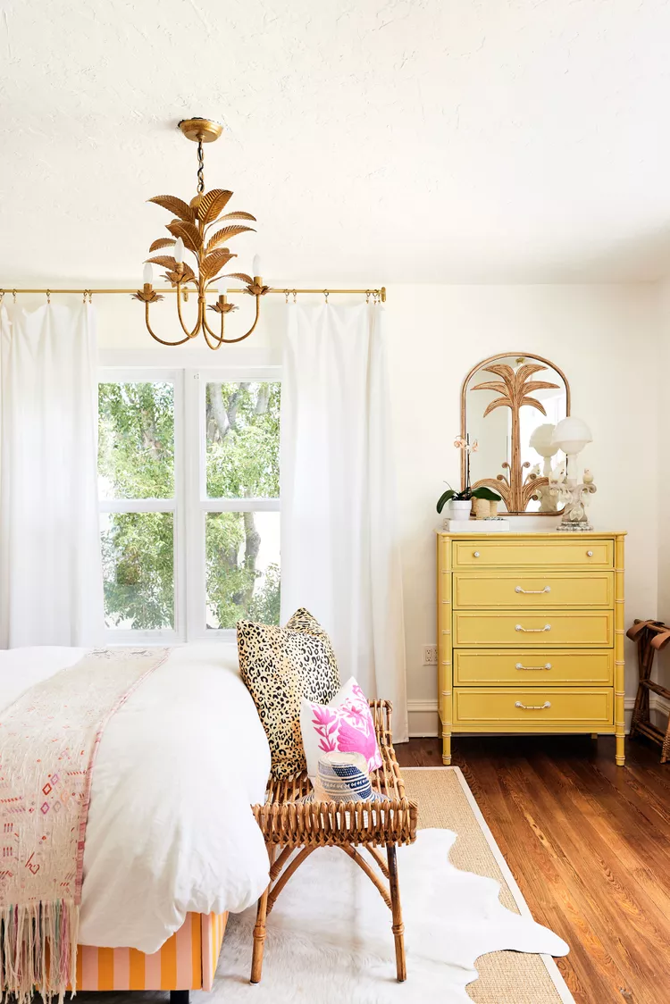 bedroom with yellow dresser and tropical decor