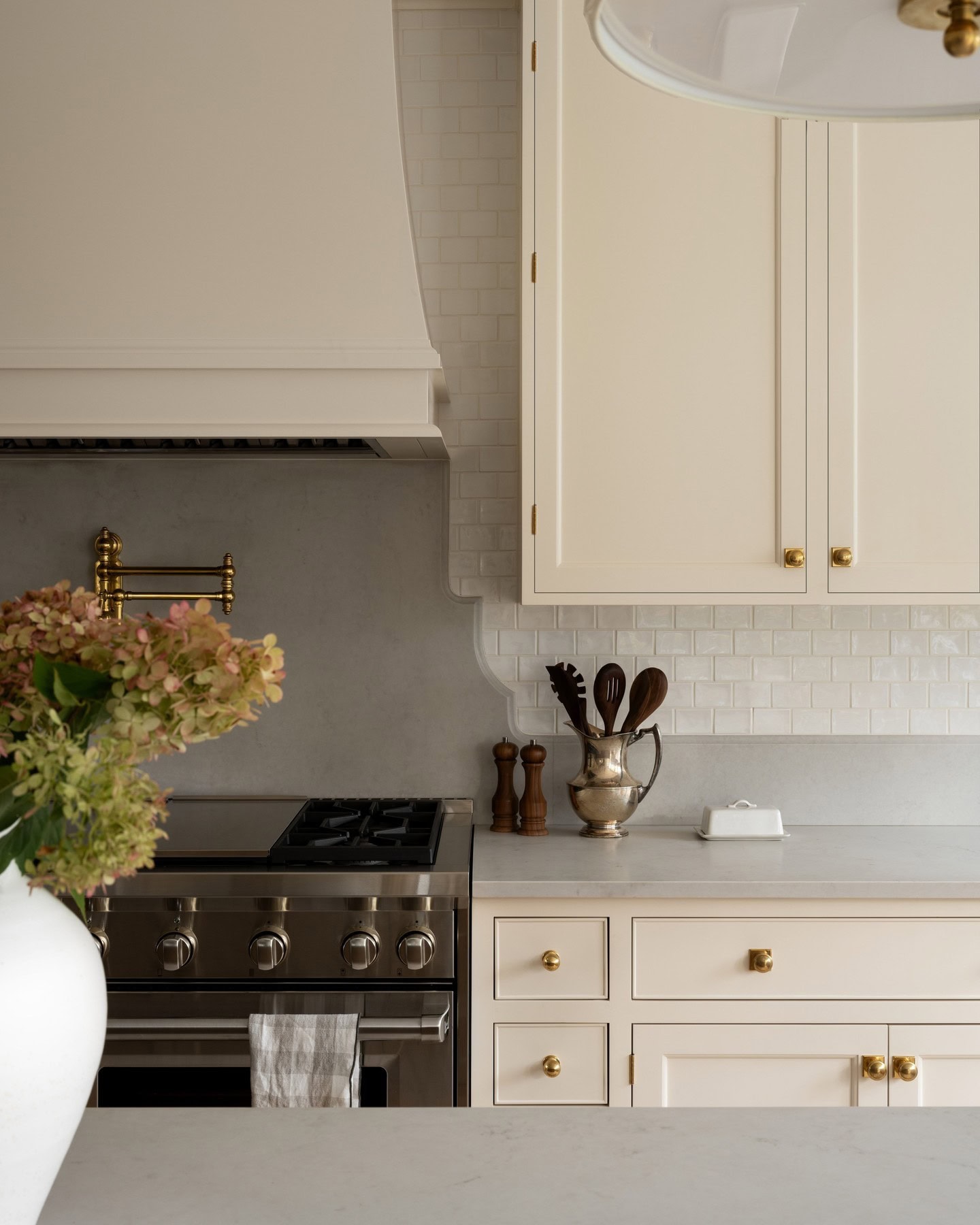 Neutral kitchen cabinet colors example featuring a modern traditional kitchen idea with warm toned gray cabinets.