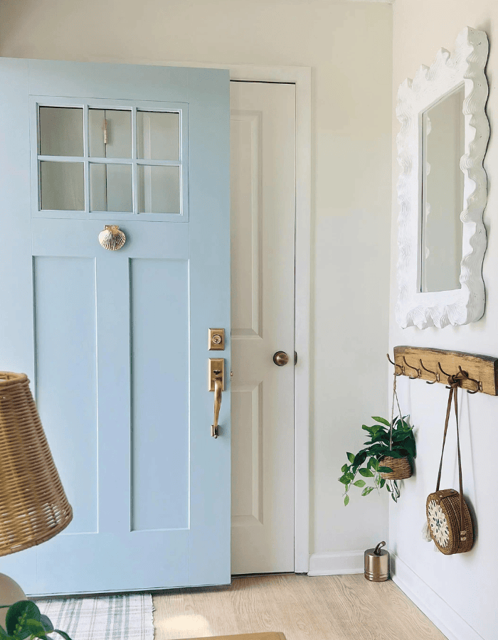 Example of modern foyer decorating ideas featuring wall-mounted coat rack