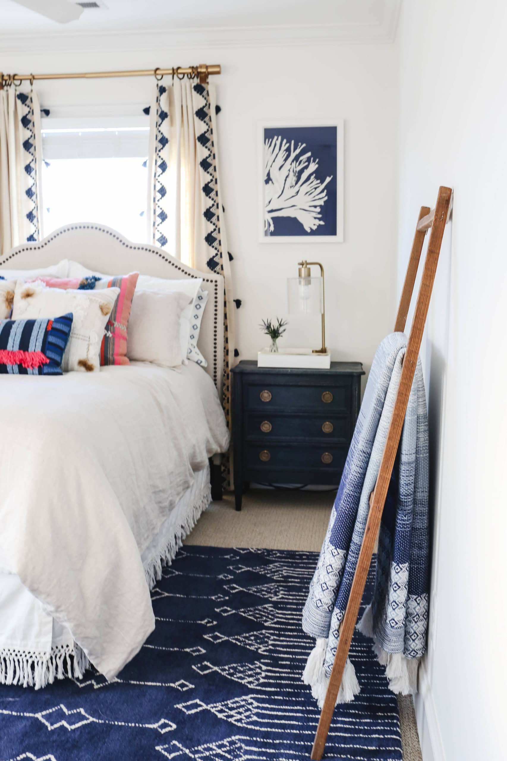 Modern beach style bedroom with wood flooring and coastal accents