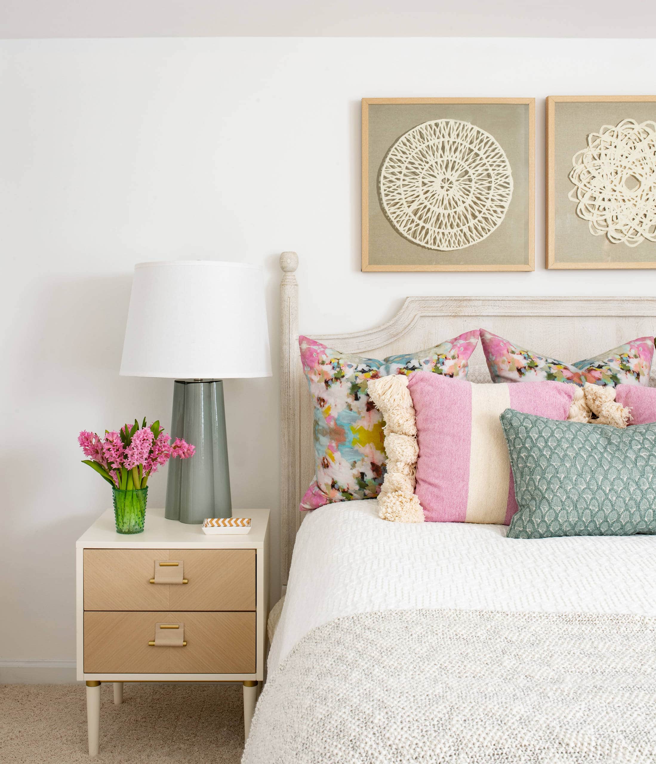 Modern beach style bedroom with pink pillows and coastal accents