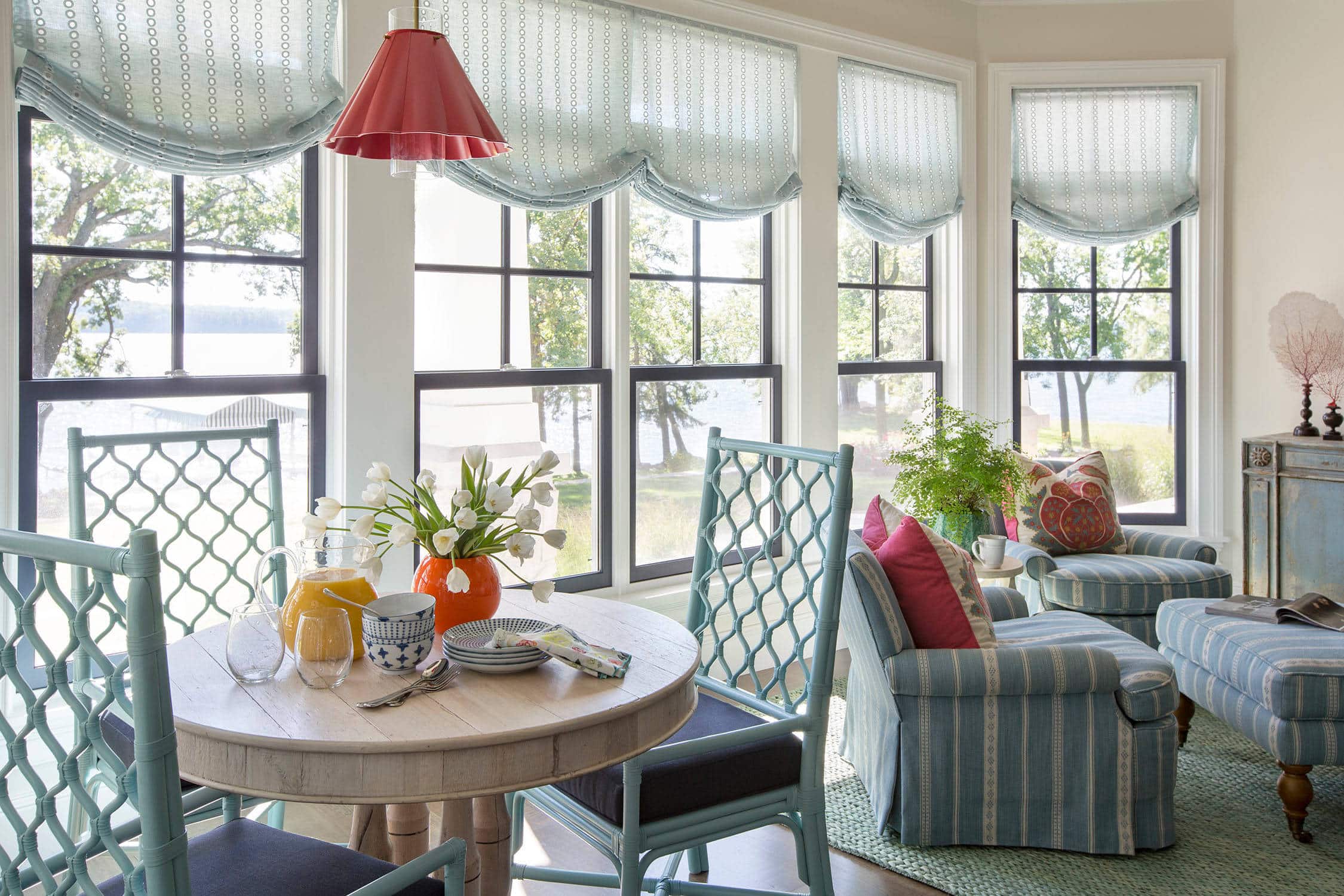 Coastal lake house with colorful tropical accents featuring a sunroom