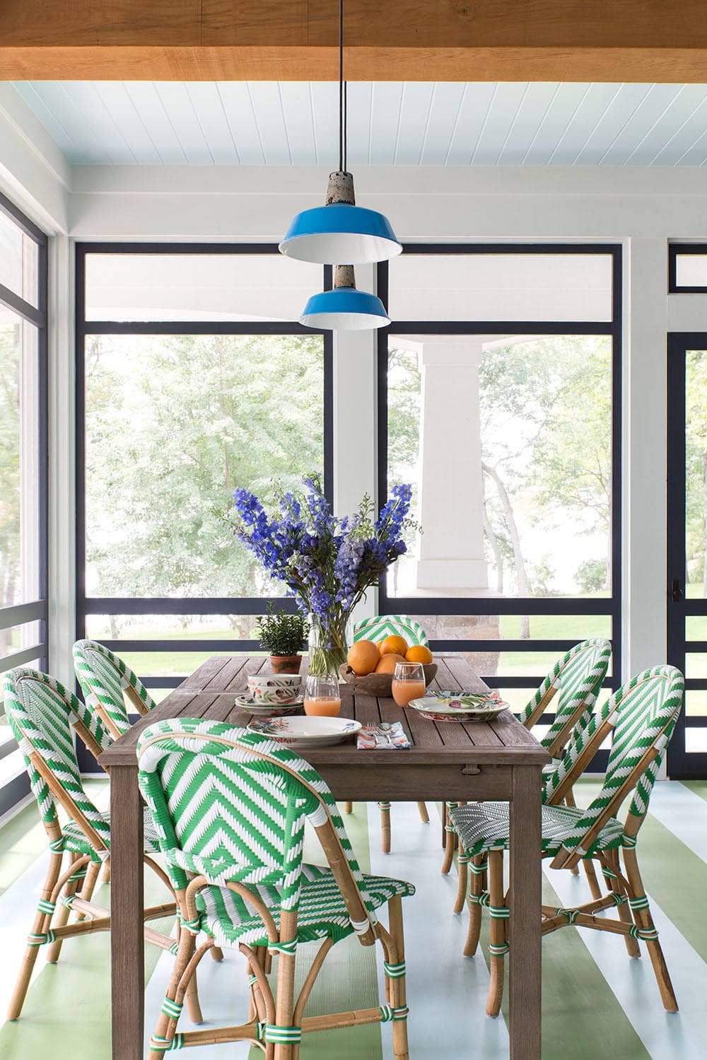 Coastal lake house with colorful tropical accents featuring a sunroom