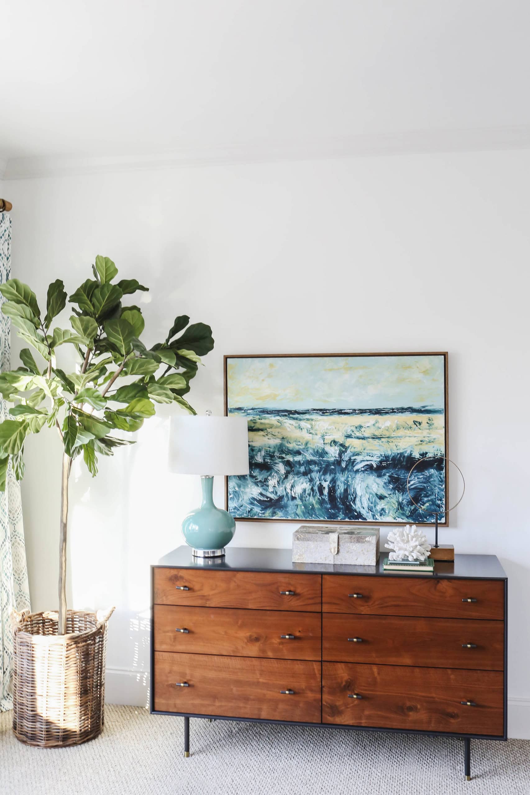 Modern beach style bedroom with wood drawer and coastal accents