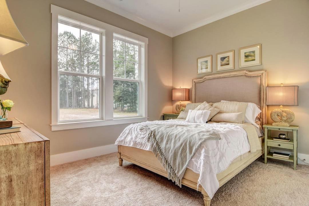 Modern beach style bedroom with wood flooring and coastal accents