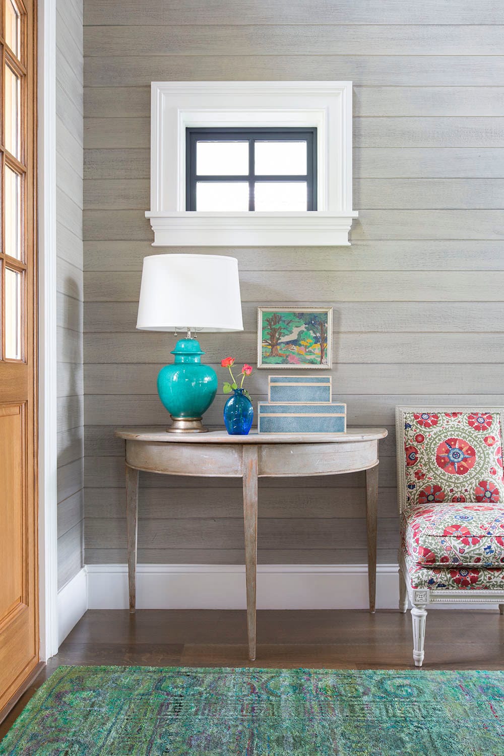 Coastal lake house with colorful tropical accents featuring a entryway