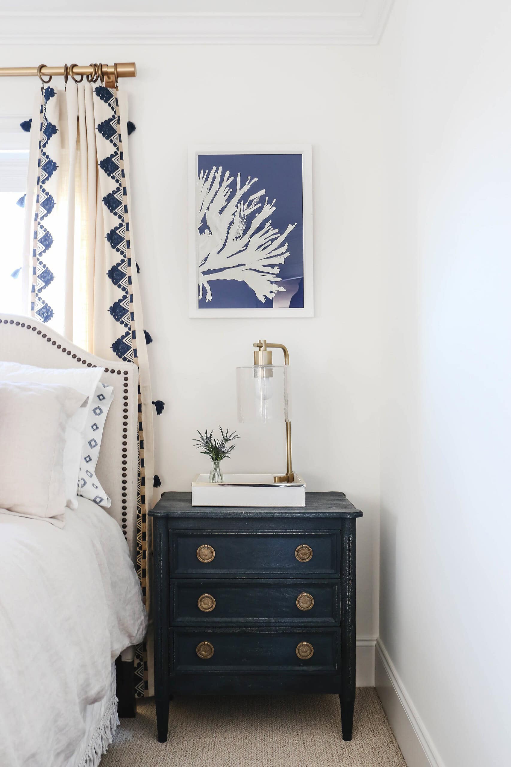 Modern beach style bedroom with a white and blue color sceheme and coastal accents