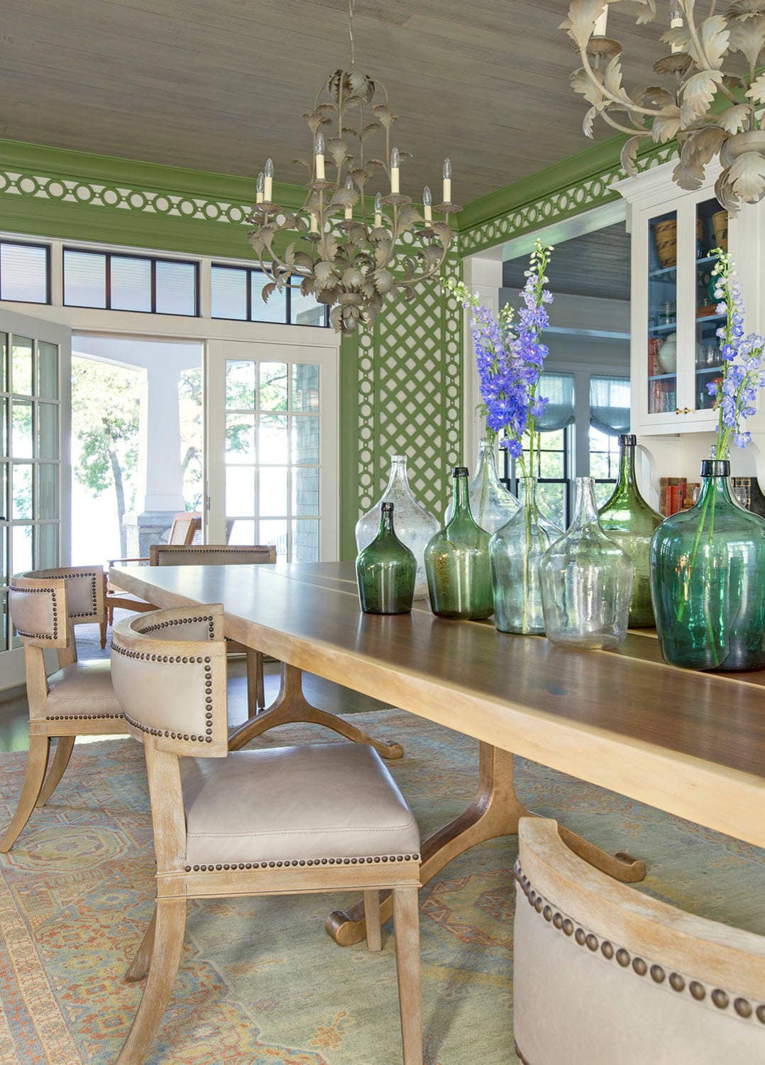 Coastal lake house with colorful tropical accents featuring a dining room