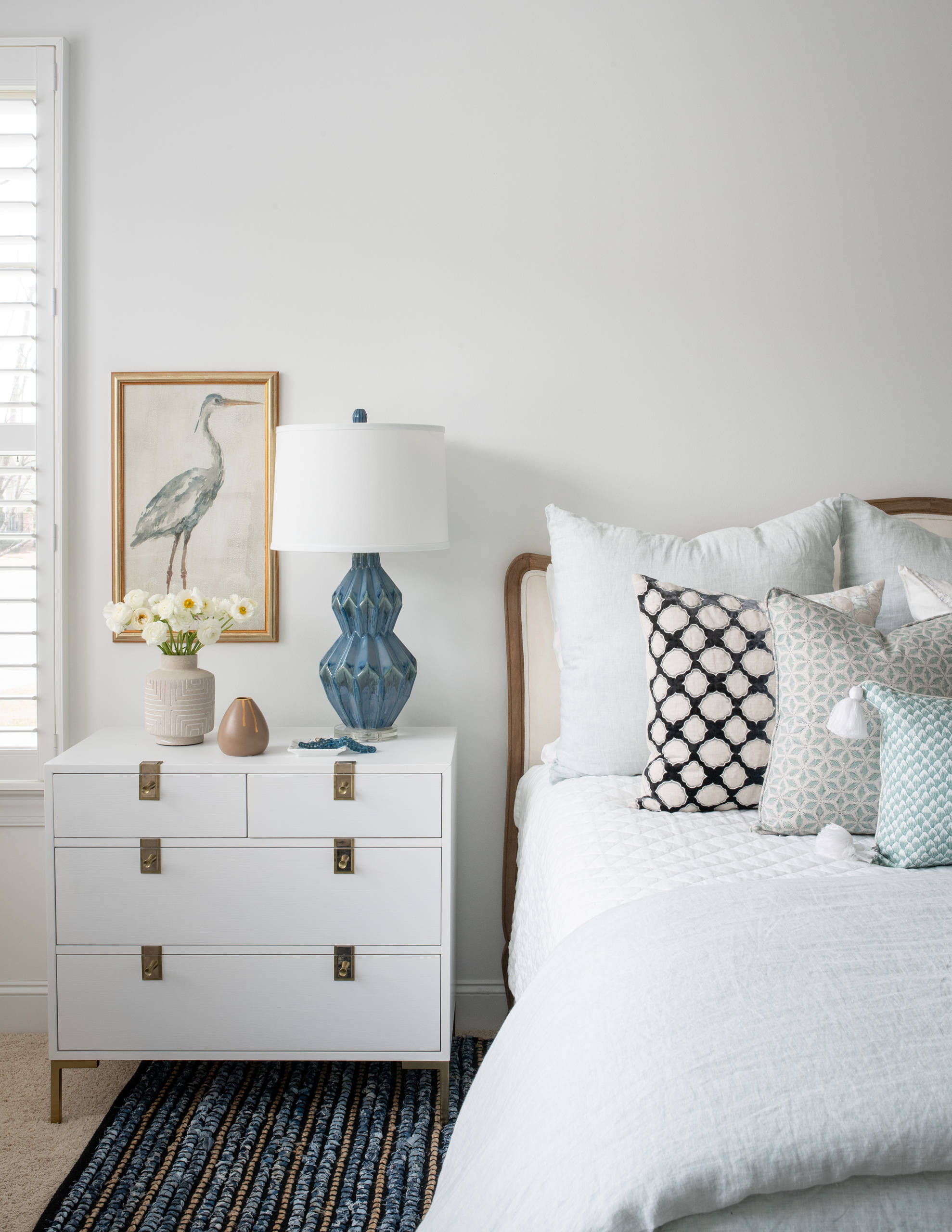 Modern beach style bedroom with wood flooring and coastal accents